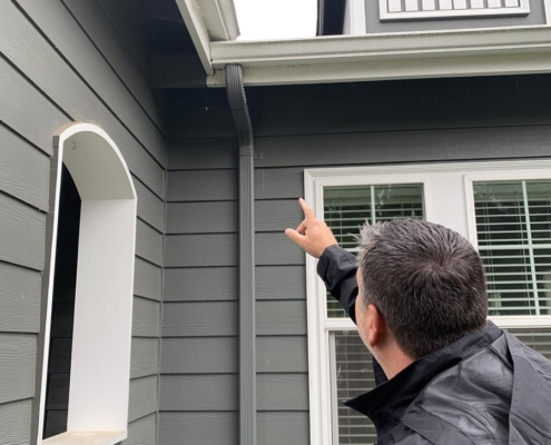 Max Stephenson, MaxPro Inspection Pointing to Roof Gutter